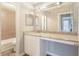 Bathroom vanity featuring granite countertops, a large mirror, and white cabinets at 602 Granville Ct, Sandy Springs, GA 30328