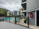 Relaxing community pool with deck, black metal fence, and light gray siding on neighboring multi-story buildings at 602 Granville Ct, Sandy Springs, GA 30328