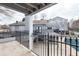 View of the community pool, with covered green safety covering, light gray siding, and black iron decorative fencing at 602 Granville Ct, Sandy Springs, GA 30328