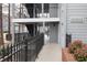 Exterior view of condominium complex featuring gray siding, black railings, and well-lit stairwells at 602 Granville Ct, Sandy Springs, GA 30328