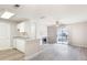 Open kitchen with white cabinets and views into the living area with a fireplace at 602 Granville Ct, Sandy Springs, GA 30328