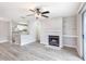 Open-concept living room with a fireplace, a modern ceiling fan and views of the kitchen area at 602 Granville Ct, Sandy Springs, GA 30328