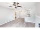 Open concept living room with light gray walls, ceiling fan, and gray wood floors at 602 Granville Ct, Sandy Springs, GA 30328