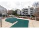 Community pool covered for the winter season with multi-level condo building in the background at 602 Granville Ct, Sandy Springs, GA 30328