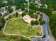 Aerial view of a community park and playground surrounded by mature trees and a parking area at 907 Fox Croft Pl, Canton, GA 30114