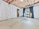 Unfinished basement with insulation, concrete floor, and natural light from a window at 907 Fox Croft Pl, Canton, GA 30114