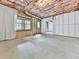 Unfinished basement featuring exposed ceiling, concrete flooring, and natural light from a window at 907 Fox Croft Pl, Canton, GA 30114