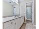 Bright bathroom featuring a granite countertop, white cabinets, and a view of the shower at 907 Fox Croft Pl, Canton, GA 30114