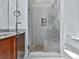 Modern bathroom featuring a glass-enclosed tiled shower with decorative tile accents and granite topped vanity at 907 Fox Croft Pl, Canton, GA 30114