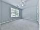 Bright bedroom with ceiling fan, neutral carpet and a patterned accent wall at 907 Fox Croft Pl, Canton, GA 30114