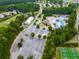 Aerial view of a community pool area with winding pools, water slides, basketball, tennis courts, and parking at 907 Fox Croft Pl, Canton, GA 30114