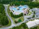 Aerial view of a large community pool featuring water slides, lounge chairs, and lush landscaping at 907 Fox Croft Pl, Canton, GA 30114