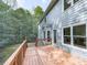 Exterior home view of a wooden deck surrounded by lush greenery at 907 Fox Croft Pl, Canton, GA 30114