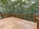 Spacious wooden deck with railings overlooking a private backyard with trees at 907 Fox Croft Pl, Canton, GA 30114