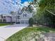 Traditional-style home with a well-maintained lawn and a driveway leading to the garage at 907 Fox Croft Pl, Canton, GA 30114