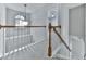 Hallway with wood railing and trim, neutral carpet, and hanging light fixture at 907 Fox Croft Pl, Canton, GA 30114