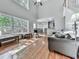 Sun-filled living room with hardwood floors, large windows, and a cozy seating area at 907 Fox Croft Pl, Canton, GA 30114