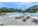 Expansive community pool with lounge chairs, tables, umbrellas, and a slide at 907 Fox Croft Pl, Canton, GA 30114