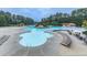 Large community pool with plenty of chairs, tables, and umbrellas for residents at 907 Fox Croft Pl, Canton, GA 30114