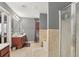 Bright bathroom features a double sink vanity, separate shower, and tiled soaking tub at 1600 Yukon Ct, Atlanta, GA 30349
