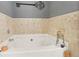 Corner bathtub with tile surround and decor at 1600 Yukon Ct, Atlanta, GA 30349