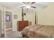 Bedroom with four-poster bed, ceiling fan, and view into en-suite bathroom at 1600 Yukon Ct, Atlanta, GA 30349