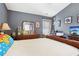 Comfortable bedroom with a bed, wooden dresser, and playful superhero-themed decor at 1600 Yukon Ct, Atlanta, GA 30349