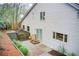 Exterior of home with a patio area, stairway up to the backyard and mature landscaping at 925 Ivy Falls Dr, Atlanta, GA 30328