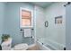 Cozy bathroom with a glass shower, neutral tile, toilet, and decorative storage nook at , Marietta, GA 30068