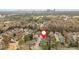 Stunning aerial view of a neighborhood surrounded by lush trees, with a city skyline in the background at 1005 Brookhaven Ne Walk, Brookhaven, GA 30319