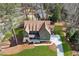 Aerial view of a well-maintained home with manicured lawn, lush trees, and a long driveway at 1445 Ashwoody Ne Ct, Atlanta, GA 30319