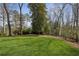 Lush backyard featuring mature trees and a well-maintained lawn at 1445 Ashwoody Ne Ct, Atlanta, GA 30319