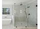 Modern bathroom with a glass enclosed shower, standalone tub, and a herringbone tile accent wall at 1445 Ashwoody Ne Ct, Atlanta, GA 30319