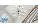 Modern chandelier with globe lights accents the staircase and transom window at 1445 Ashwoody Ne Ct, Atlanta, GA 30319