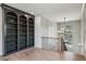 Hallway showcasing a custom built-in bookcase, hardwood floors, and a stylish chandelier at 1445 Ashwoody Ne Ct, Atlanta, GA 30319