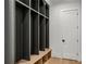 Custom mudroom features a dark cubby system and wood bench for added storage at 1445 Ashwoody Ne Ct, Atlanta, GA 30319