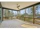 Large covered porch has wood flooring, natural wood posts and railings, and a ceiling fan at 1445 Ashwoody Ne Ct, Atlanta, GA 30319