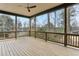 Spacious covered porch with natural wood flooring and a ceiling fan, perfect for outdoor relaxation at 1445 Ashwoody Ne Ct, Atlanta, GA 30319