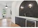 Stylish wet bar with dark tiled backsplash, white countertop, wine cooler and hardware finishes at 1445 Ashwoody Ne Ct, Atlanta, GA 30319