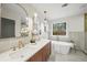 Elegant bathroom featuring a double sink vanity and freestanding soaking tub with modern finishes at 1788 Piper Se Cir, Atlanta, GA 30316