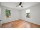 Bright, airy bedroom with hardwood floors, modern ceiling fan, and views of the landscaped yard at 1788 Piper Se Cir, Atlanta, GA 30316