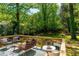 Cozy deck area showcasing stylish outdoor furniture, a patterned rug, and a tranquil backyard setting at 1788 Piper Se Cir, Atlanta, GA 30316