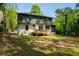 Back exterior of home with modern design and a spacious wooden deck, set in a green yard at 1788 Piper Se Cir, Atlanta, GA 30316
