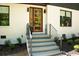 Modern home showcasing striking entrance with new brick, wood door, and updated landscaping at 1788 Piper Se Cir, Atlanta, GA 30316