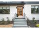 Modern home showcasing striking entrance with new brick, wood door, and updated landscaping at 1788 Piper Se Cir, Atlanta, GA 30316