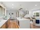 Open-concept kitchen features a large island, stainless steel appliances, and a view of the stairs and living room at 1788 Piper Se Cir, Atlanta, GA 30316