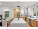 Bright kitchen featuring a large island, stainless steel appliances, and a mix of white and wood cabinets at 1788 Piper Se Cir, Atlanta, GA 30316