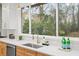 Updated kitchen with stainless steel appliances, stone countertops, white tile backsplash and large view window at 1788 Piper Se Cir, Atlanta, GA 30316
