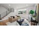 Cozy living room with modern staircase, large windows, hardwood floors, and comfortable seating at 1788 Piper Se Cir, Atlanta, GA 30316