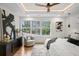Bright main bedroom featuring tray ceilings, large windows, hardwood floors, stylish decor and modern furnishings at 1788 Piper Se Cir, Atlanta, GA 30316